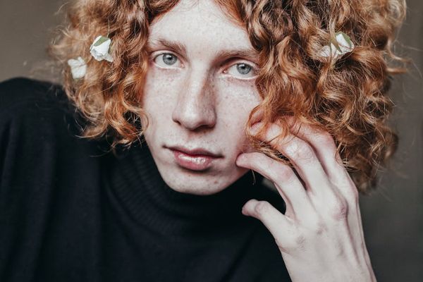 Person standing on top of a hill looking at horizon.